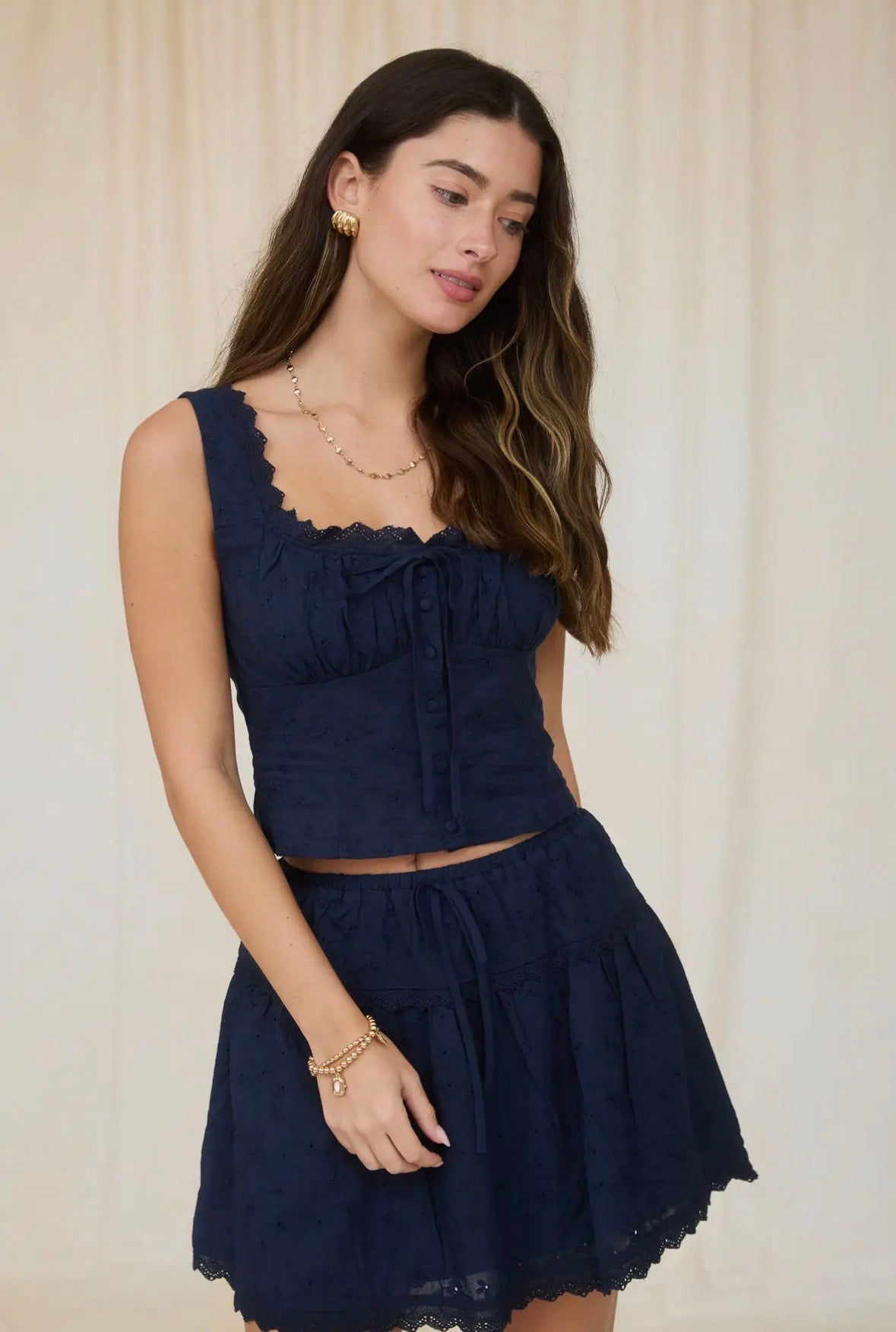 Woman wearing a navy blue dress with a plain background