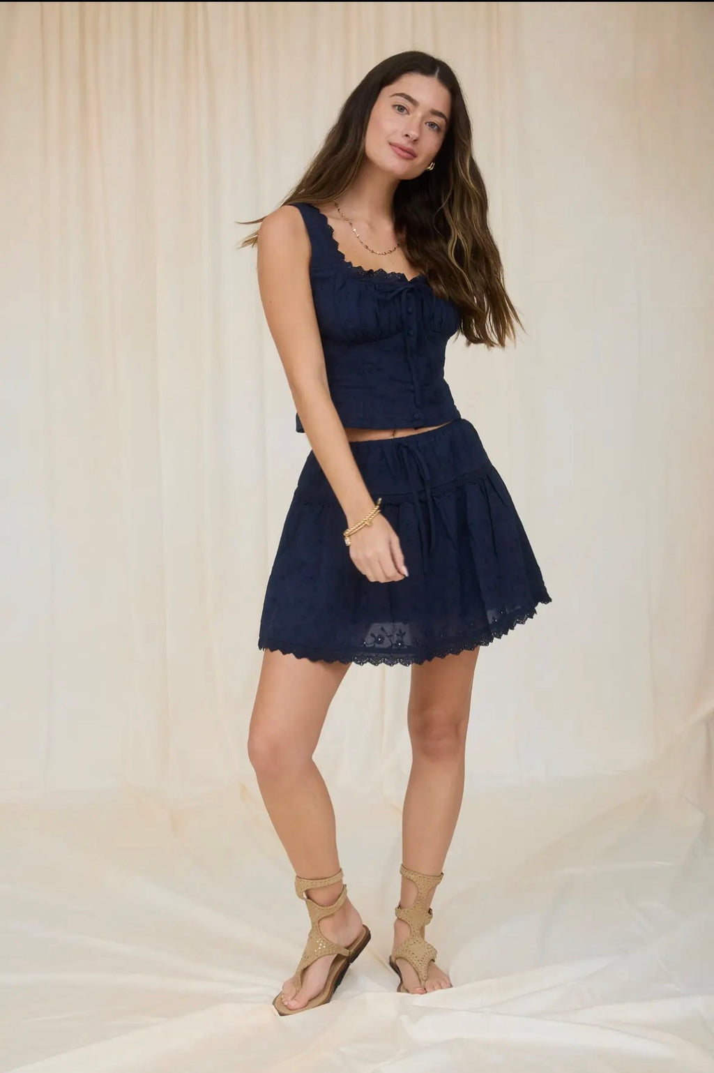 Woman wearing a navy blue dress against a plain background