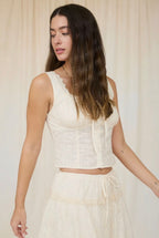 Woman wearing a white outfit with a plain background