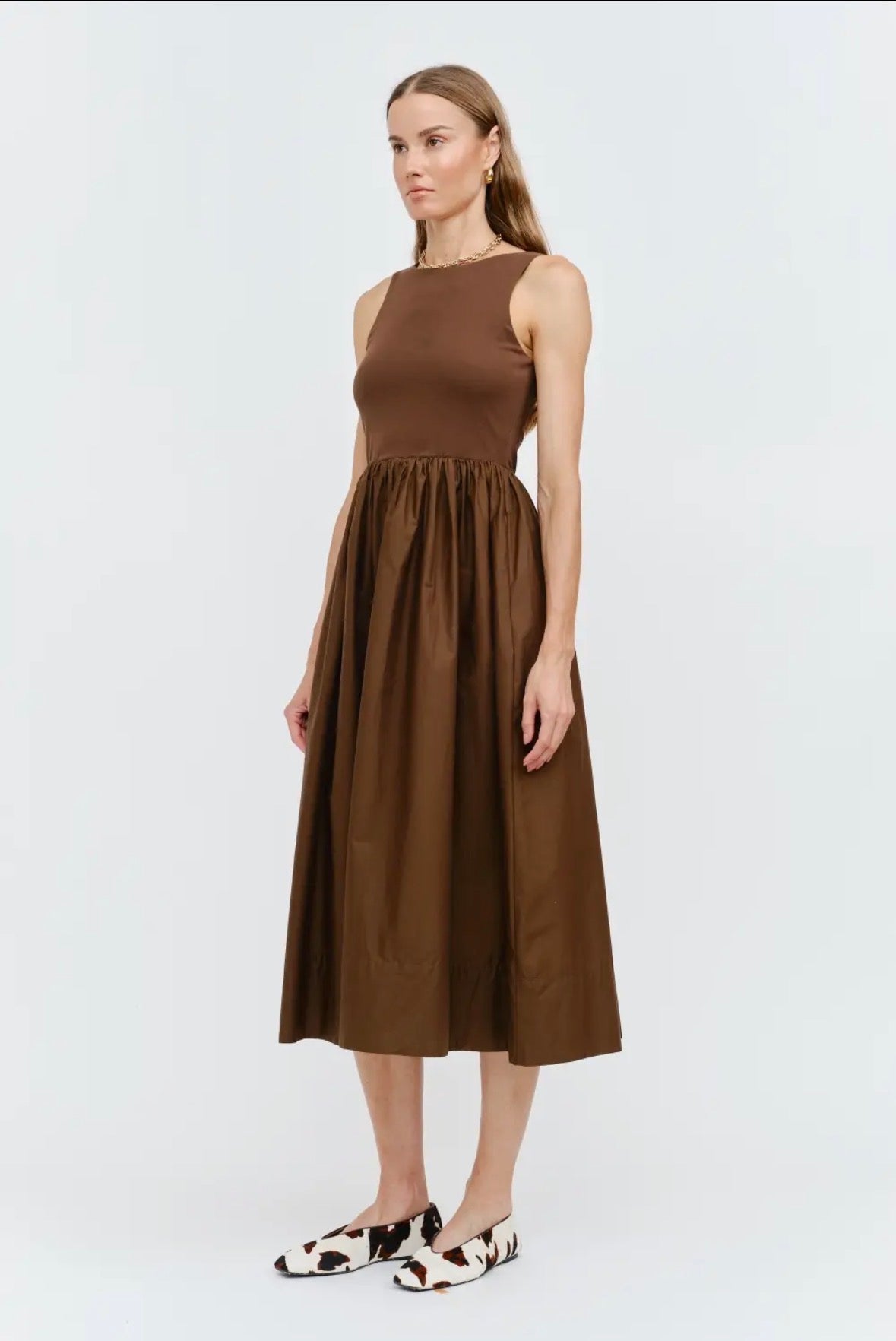 Woman wearing a brown dress on a white background
