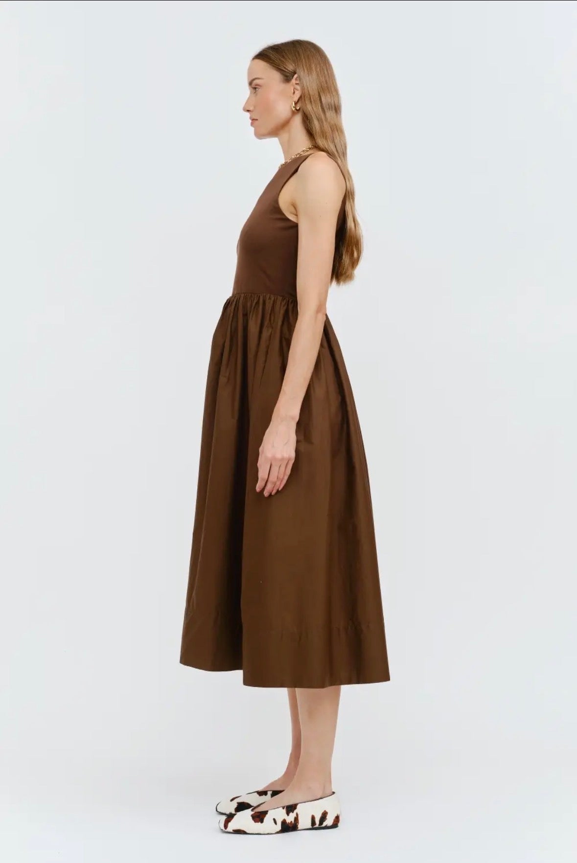 Woman wearing a brown dress on a white background