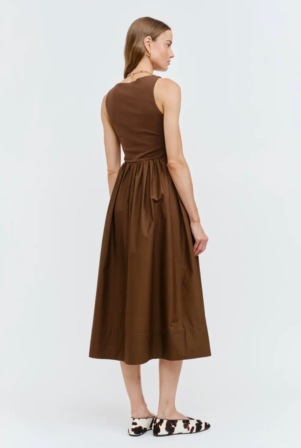 Woman wearing a brown dress on a white background