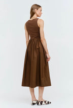 Woman wearing a brown dress on a white background