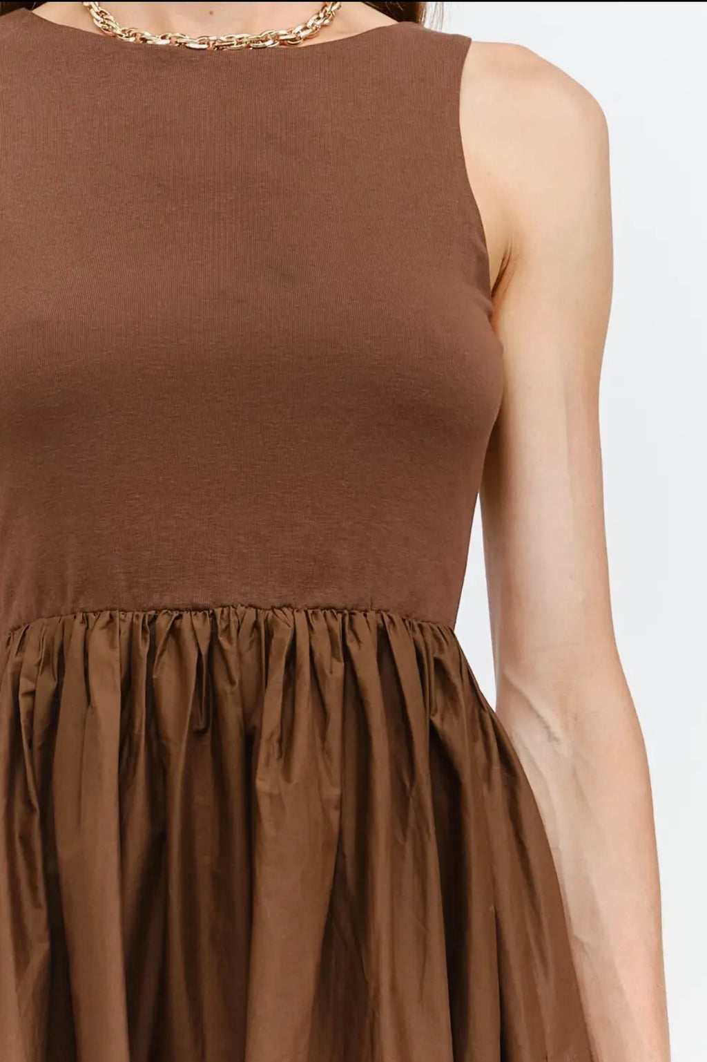 Brown sleeveless dress with a plain background